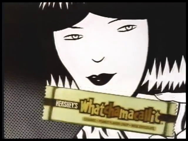 the late 80s Whatchamacalit commercial. A woman in a black and white Pop Art comic book style holds a Whatchamacalit bar, still in its yellow wrapper. The candy is the only thing in frame in color.