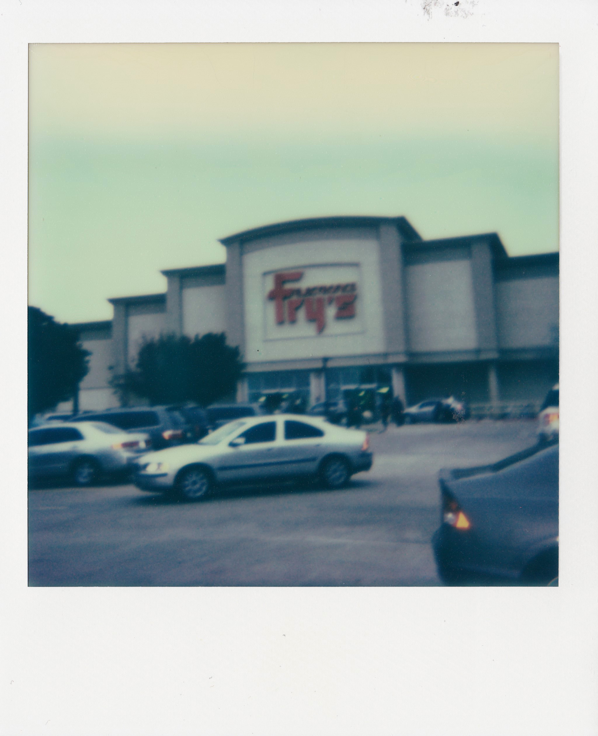 Fry's Electronics in Irving, TX. This one's kinda blurry but I still like it.<br>Polaroid OneStep Flash, Impossible Project film.