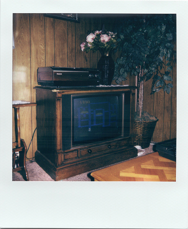 A fake 1980s living room inside the National Videogame Museum. The game on screen is the Intellivision version of BurgerTime. This is my ideal atmosphere. In my dreams, I am here.<br> Polaroid One, 600 Film